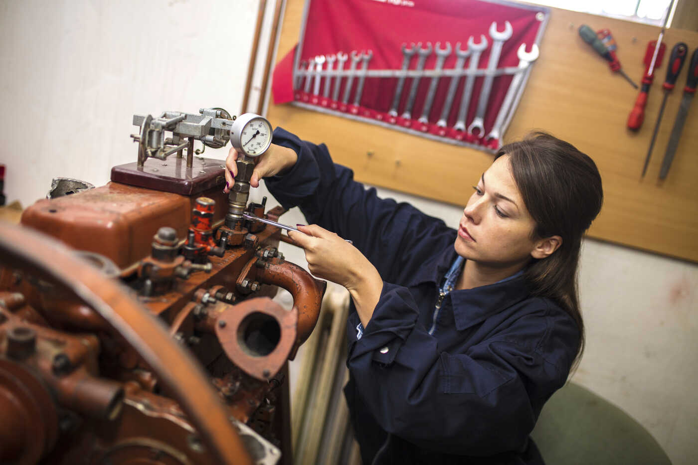 Woman in agriculture working on engine